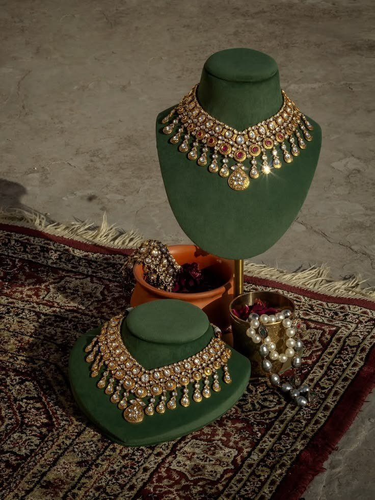 Heritage necklaces on emerald busts